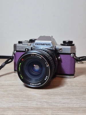 Olympus OM-10 35mm SLR film camera used with Tokina RMC 28-50mm lens