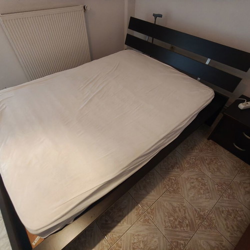 Complete dark wood bedroom set with double bed and bedside table