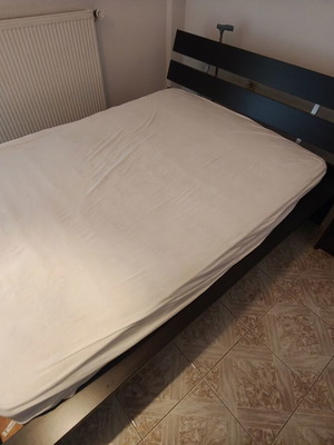 Complete dark wood bedroom set with double bed and bedside table