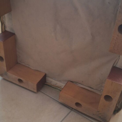 Light green fabric-covered stool with wooden legs