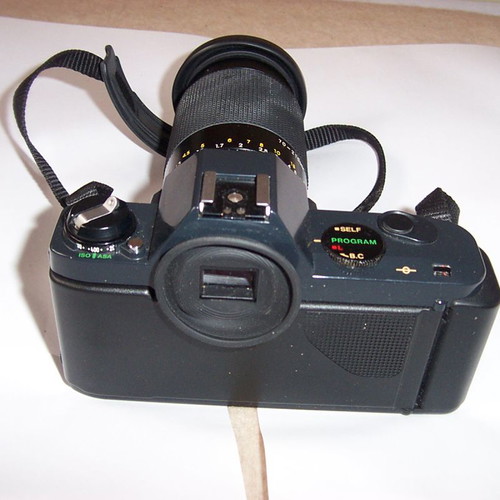Canon T50 SLR analog camera used with two zoom lenses and flash
