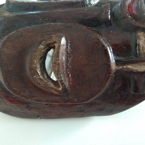Handmade wooden mask used with aged patina