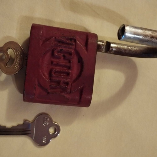 Old padlock used with key and skeleton key