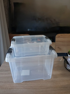 Set of 2 transparent plastic storage boxes with grey clips