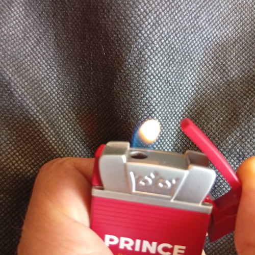 Prince lighter red metal promotional like new