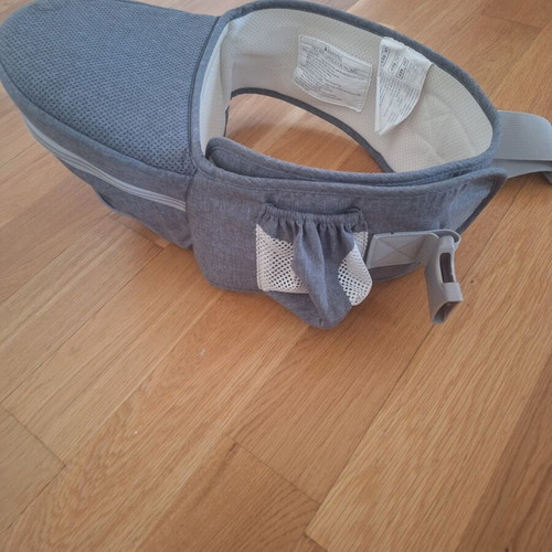Gabesy ergonomic hip seat carrier used with branded baby toys