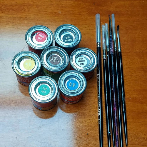 Various jars with colors and brushes