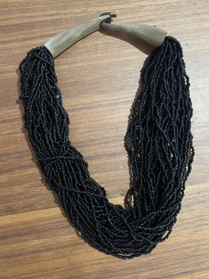 Handmade multi-strand black seed bead necklace with natural wooden clasp used