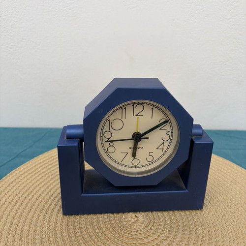Blue analog table clock used, missing battery cover