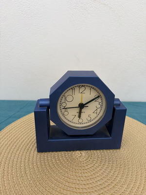 Blue analog table clock used, missing battery cover