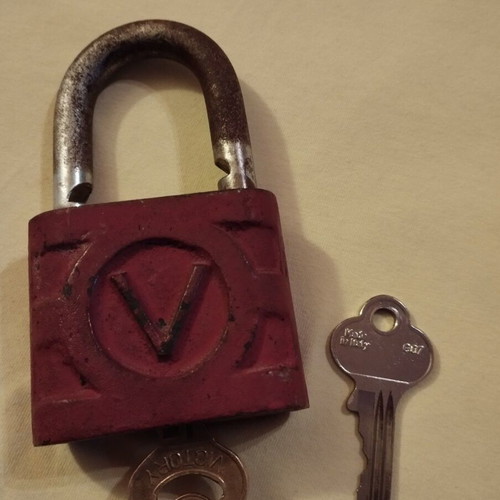 Old padlock used with key and skeleton key
