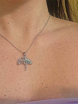 Silver necklace like new with tree design and green stones