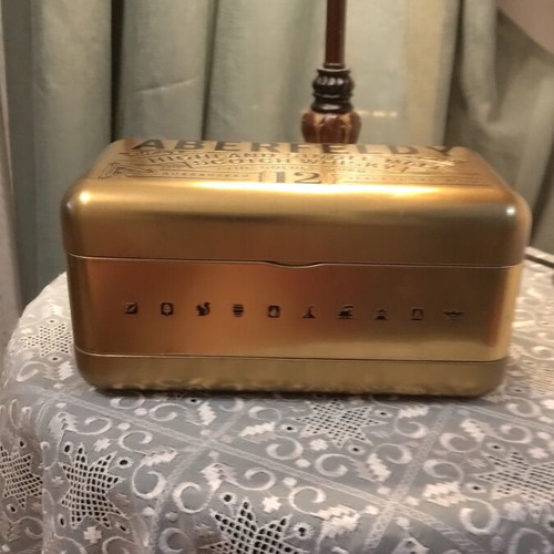 Bottle holder with collectible bottle like new, metal gold color