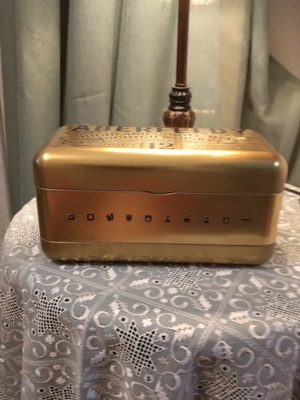 Bottle holder with collectible bottle like new, metal gold color