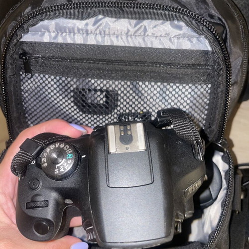 Canon EOS 1200D camera kit with lenses, memory card, battery, charger, and carrying bag