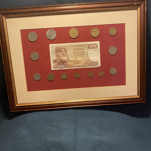 Collection of Greek drachma coins used with thousand drachma note