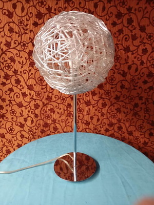 Modern table lamp used with chrome base and acrylic globe
