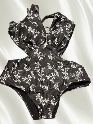 One-piece swimsuit used, black with floral print, size M