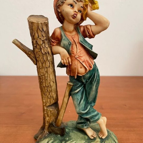 Figurine boy with axe and tree stump