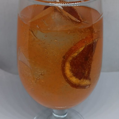 Handmade candle in Aperol Spritz glass with Aperol Spritz scent