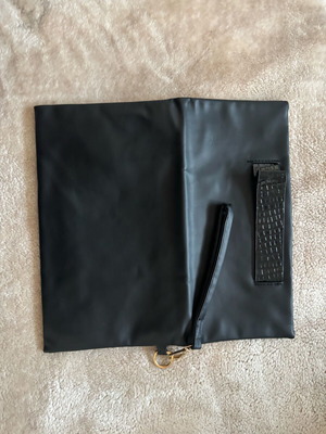 Handheld black clutch bag like new with leather detail
