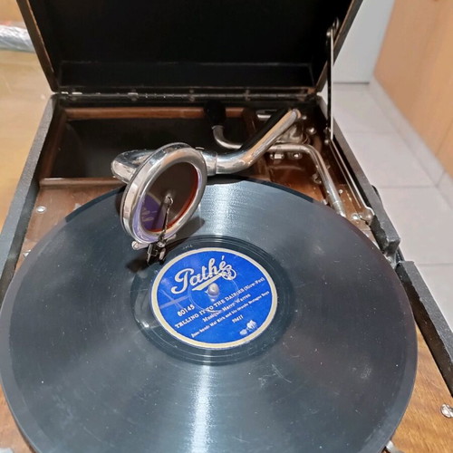 His Master's Voice portable gramophone used with accessories