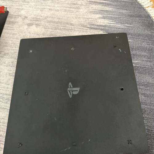 Sony PlayStation 4 Pro 1TB console used with controllers and charging dock