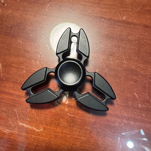 Metal fidget spinner used, black ninja star shuriken design