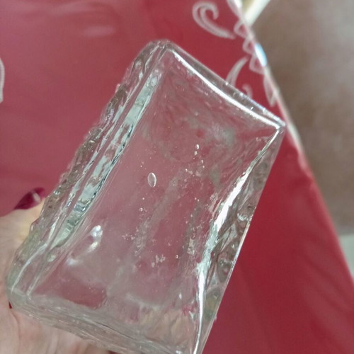 Vintage glass decanter with embossed geometric design and stopper