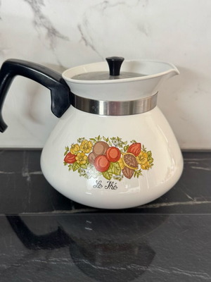 Vintage enameled French kettle used with floral motifs