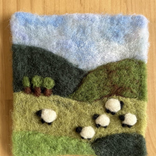 Handmade wool felt landscape picture with sheep
