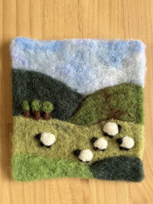 Handmade wool felt landscape picture with sheep