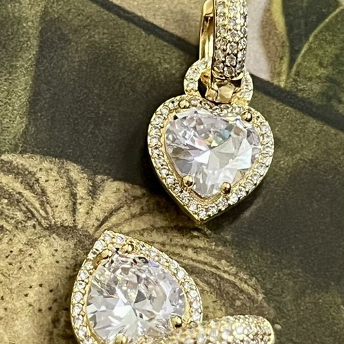 Gold-tone earrings with heart-shaped transparent stone and zircon details