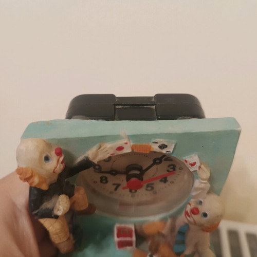 Vintage miniature table clock with clown and circus theme, used