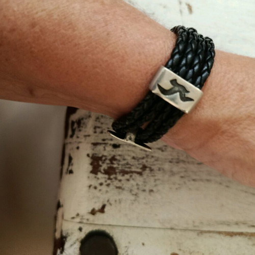 Black leather-type bracelet with silver elements used