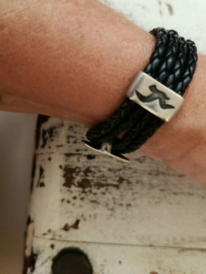 Black leather-type bracelet with silver elements used