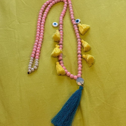 Long necklace with pink stones and evil eyes used, yellow and petrol tassels
