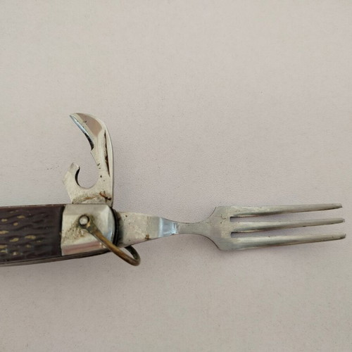 Vintage pocket knife with integrated fork and spoon, used