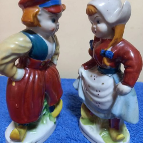 Porcelain figurines used, boy and girl in traditional Dutch costume