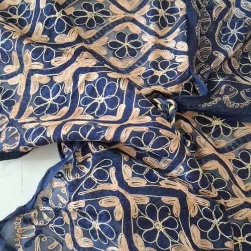 Blue embroidered decorative square used with gold thread