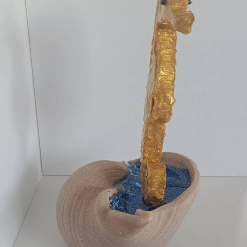 Handmade decorative gold seahorse from clay and resin with brown shell base