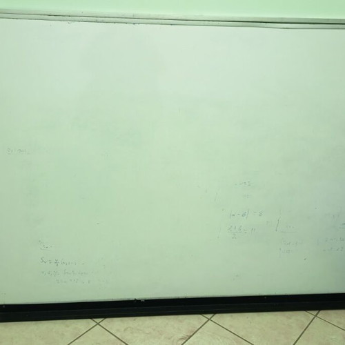 Whiteboard used for tutoring with metal frame and marker shelf