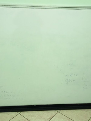 Whiteboard used for tutoring with metal frame and marker shelf