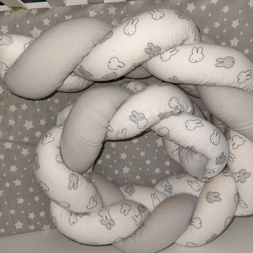 Baby braided crib bumper used in gray and white