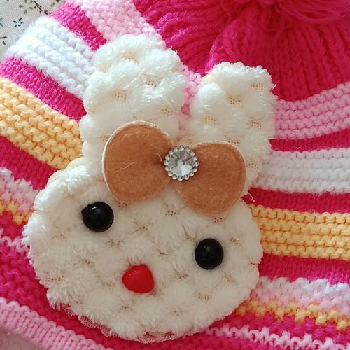 Knitted baby hat with pom pom and cute bunny design, like new