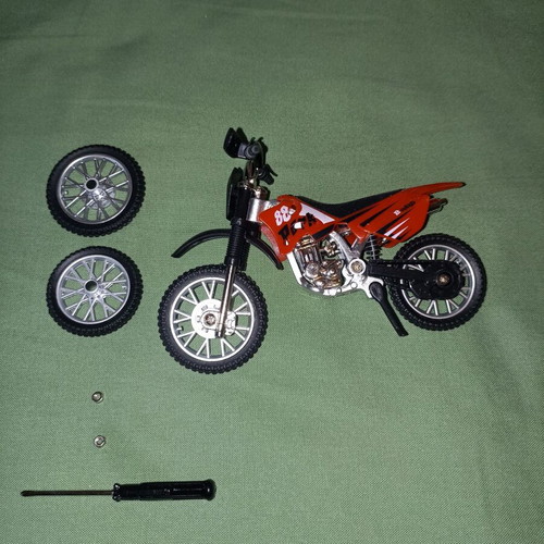 Motocross toy miniature new with extra wheels and nuts