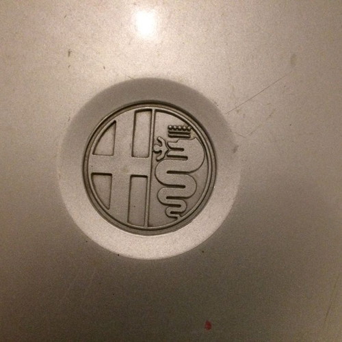 Alfa Romeo 75 hubcap used with scratches and marks