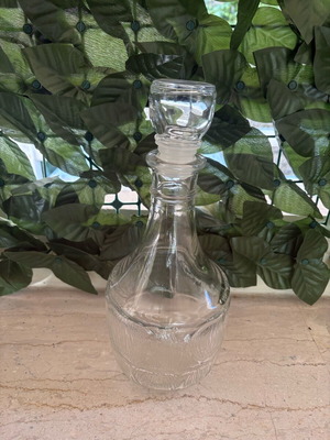 Vintage glass decanter with stopper and embossed design like new