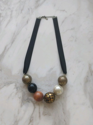Accessorize necklace used with black thick ribbon and large beads