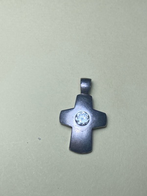 Silver cross used with stone